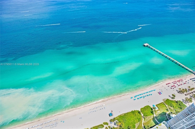 birds eye view of property with a beach view and a water view