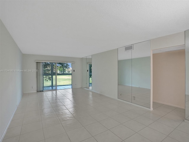 3501 Bimini Ln Unit K2, Coconut Creek, FL 33066 - unfurnished room featuring visible vents, baseboards, and light tile patterned floors