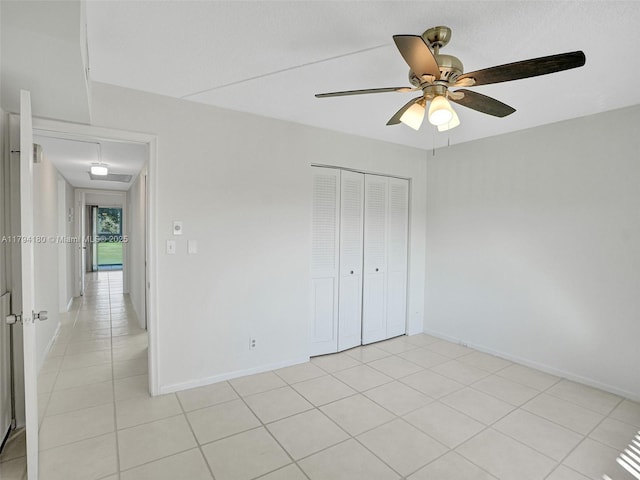 3501 Bimini Ln Unit K2, Coconut Creek, FL 33066 - unfurnished bedroom featuring baseboards, ceiling fan, light tile patterned floors, and a closet