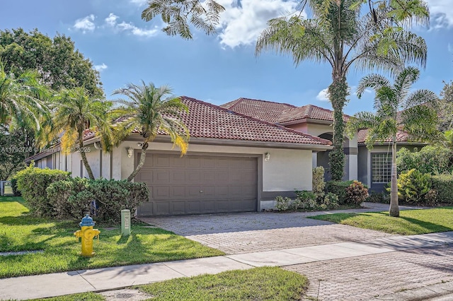 1081 SW 156th Ave, Pembroke Pines, FL 33027 - mediterranean / spanish-style home with an attached garage, a front lawn, stucco siding, decorative driveway, and a tile roof