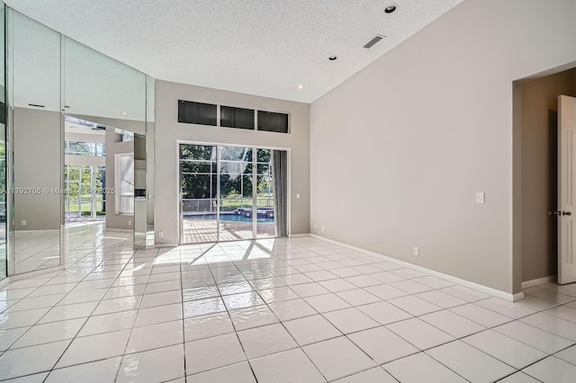 1081 SW 156th Ave, Pembroke Pines, FL 33027 - empty room with high vaulted ceiling, a textured ceiling, light tile patterned floors, baseboards, and recessed lighting