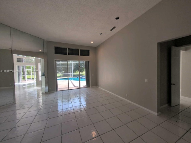 empty room with visible vents, baseboards, recessed lighting, a textured ceiling, and light tile patterned floors