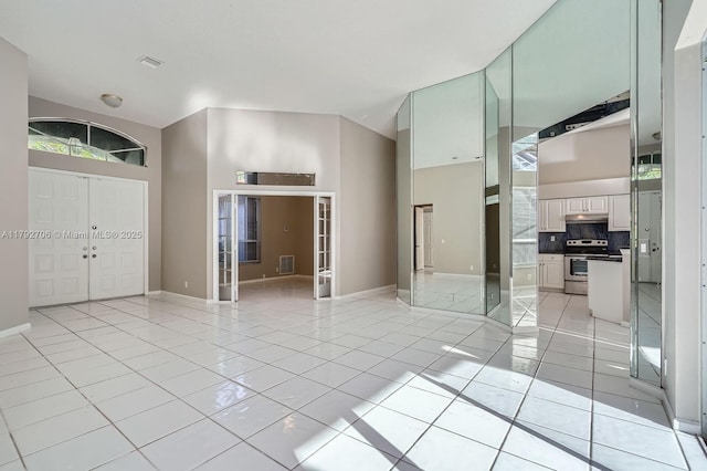 1081 SW 156th Ave, Pembroke Pines, FL 33027 - empty room with baseboards, light tile patterned floors, a towering ceiling, and french doors