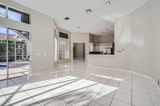 1081 SW 156th Ave, Pembroke Pines, FL 33027 - unfurnished living room with light tile patterned flooring, a high ceiling, baseboards, and recessed lighting