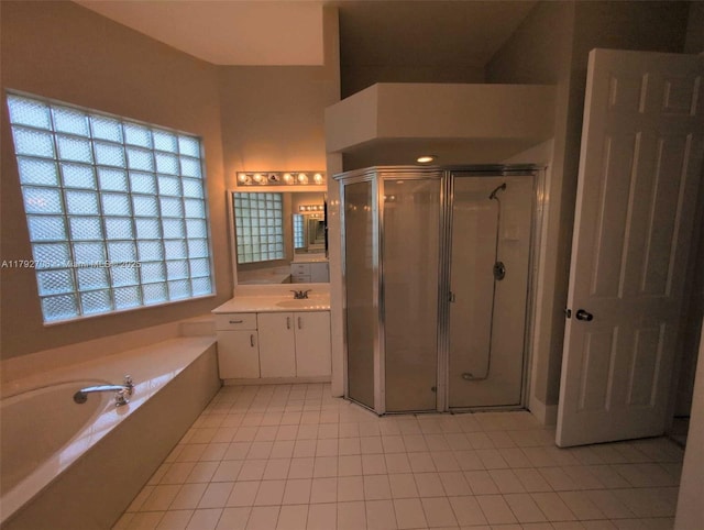 full bath featuring a garden tub, vanity, tile patterned floors, and a shower stall