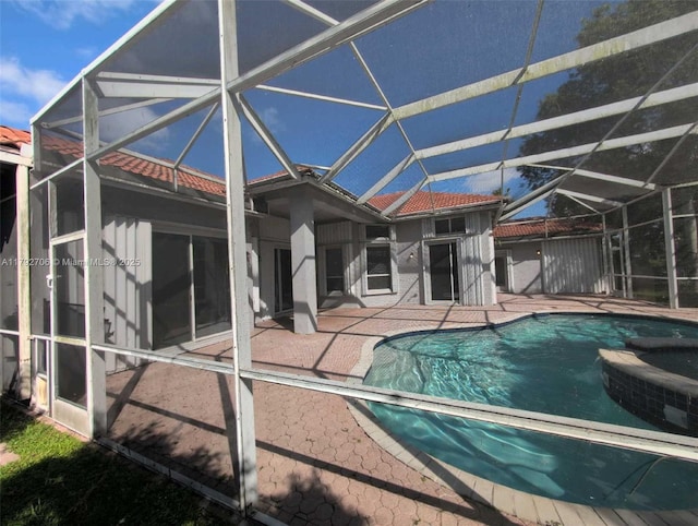 pool with a lanai and a patio area