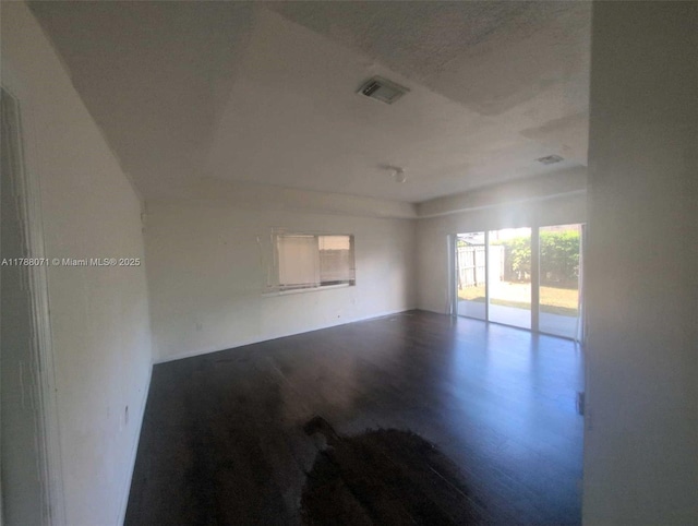 unfurnished room with visible vents and wood finished floors