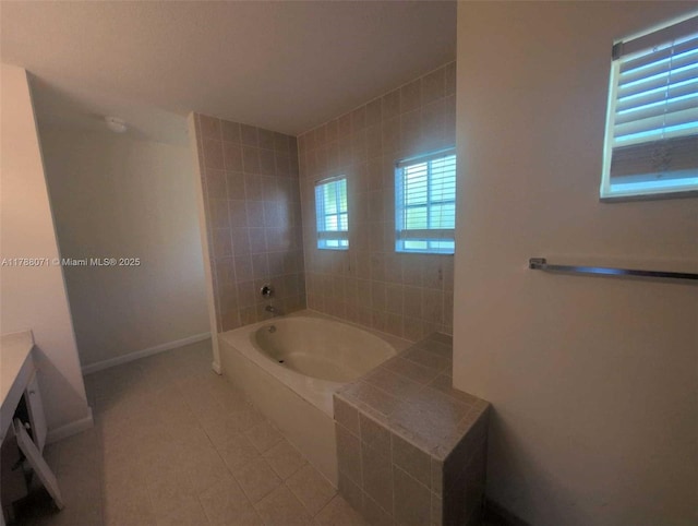 bathroom featuring a tub, baseboards, and tile patterned flooring