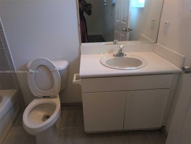 bathroom with vanity, a bath, tile patterned floors, and toilet