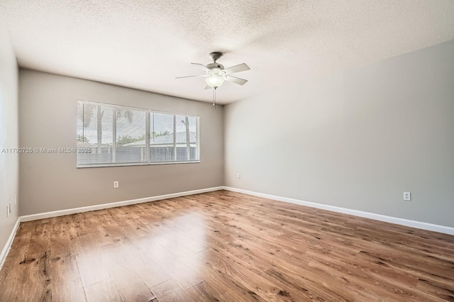 12846 SW 211th Ter, Miami, FL 33177 - empty room with wood finished floors, a ceiling fan, a textured ceiling, and baseboards