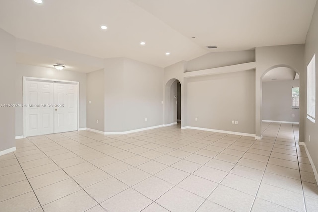 12846 SW 211th Ter, Miami, FL 33177 - empty room with arched walkways, lofted ceiling, light tile patterned flooring, baseboards, and recessed lighting