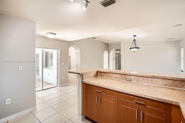 12846 SW 211th Ter, Miami, FL 33177 - kitchen featuring arched walkways, healthy amount of natural light, baseboards, pendant lighting, and a textured ceiling