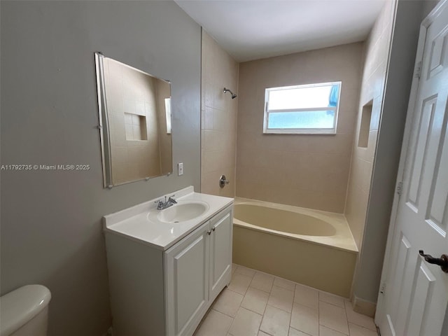 bathroom featuring toilet, shower / bathing tub combination, tile patterned flooring, and vanity