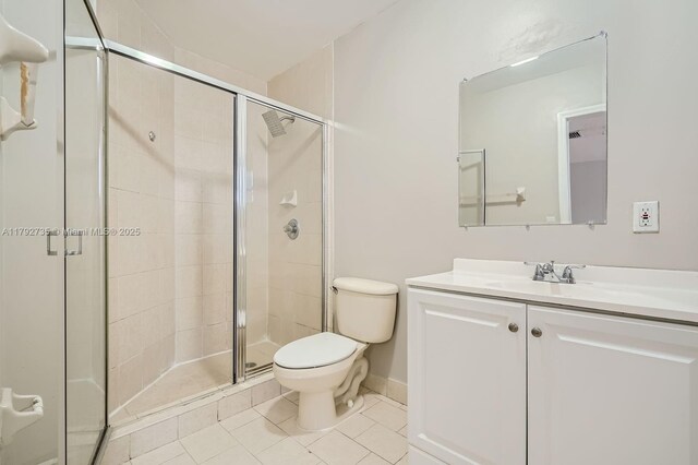 12846 SW 211th Ter, Miami, FL 33177 - bathroom featuring toilet, a stall shower, tile patterned floors, vanity, and baseboards