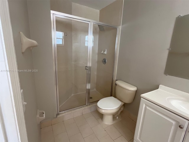 bathroom with toilet, tile patterned floors, a shower stall, and vanity