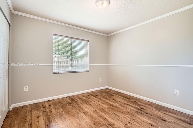 12846 SW 211th Ter, Miami, FL 33177 - unfurnished room featuring crown molding, wood finished floors, baseboards, and a textured ceiling