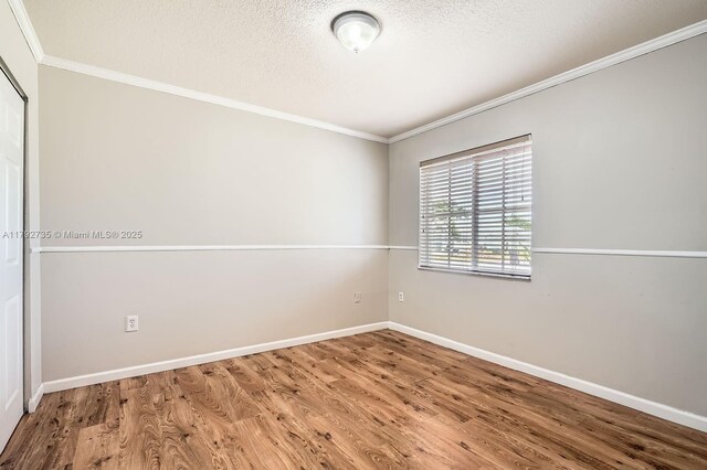 12846 SW 211th Ter, Miami, FL 33177 - unfurnished room featuring ornamental molding, wood finished floors, baseboards, and a textured ceiling