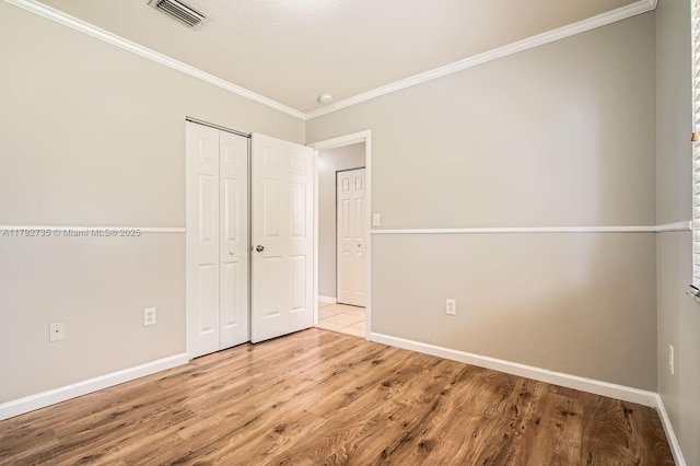 12846 SW 211th Ter, Miami, FL 33177 - unfurnished bedroom with crown molding, wood finished floors, baseboards, and a closet