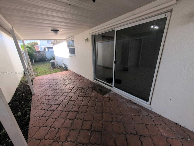 view of patio with fence and cooling unit