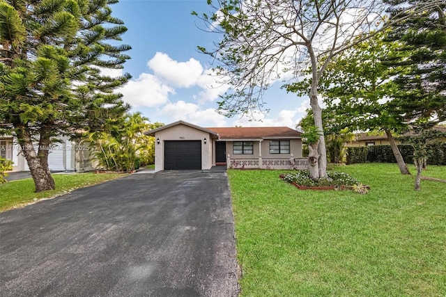 9103 NW 81st Ct, Tamarac, FL 33321 - ranch-style house with a garage, a front lawn, aphalt driveway, and stucco siding