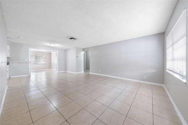 9103 NW 81st Ct, Tamarac, FL 33321 - empty room with baseboards, a textured ceiling, visible vents, and light tile patterned floors