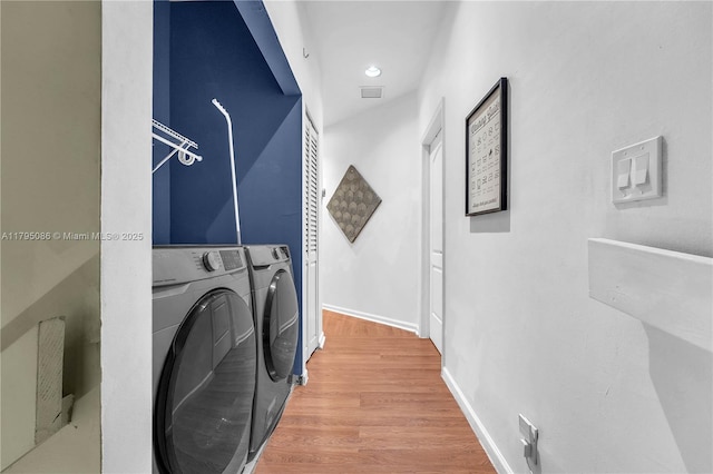2307 Washington St Unit 5, Hollywood, FL 33020 - washroom featuring washing machine and clothes dryer and wood finished floors