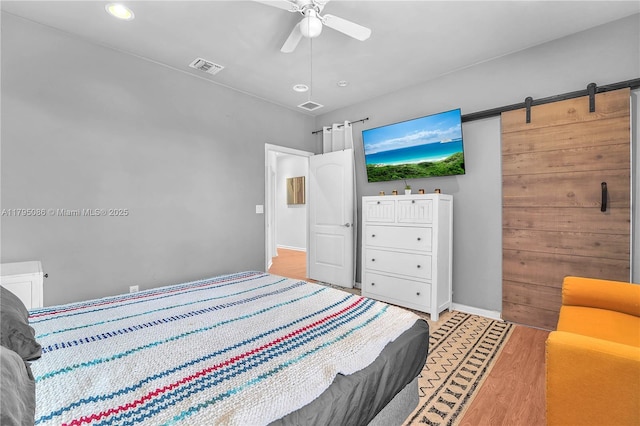 2307 Washington St Unit 5, Hollywood, FL 33020 - bedroom with light wood-style flooring, recessed lighting, ceiling fan, and a barn door