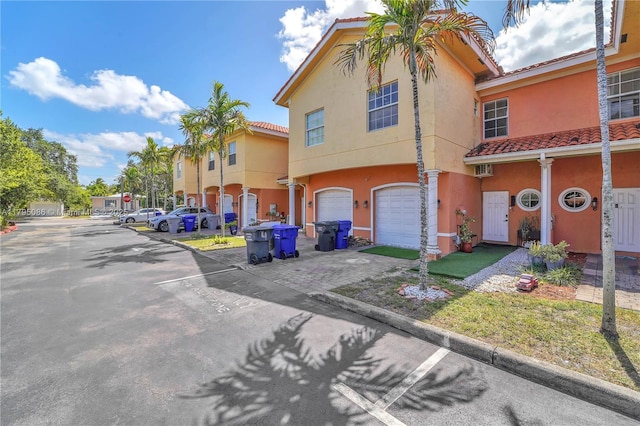 2307 Washington St Unit 5, Hollywood, FL 33020 - view of front of property with a tile roof, stucco siding, a garage, and driveway