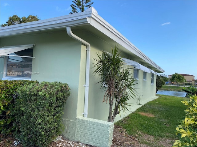 5009 NW 51st Ct, Tamarac, FL 33319 - view of side of property featuring a water view, a yard, and stucco siding