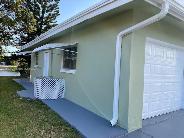 5009 NW 51st Ct, Tamarac, FL 33319 - view of side of property with stucco siding and a garage