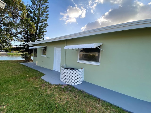 5009 NW 51st Ct, Tamarac, FL 33319 - view of side of property featuring a yard, a water view, and stucco siding