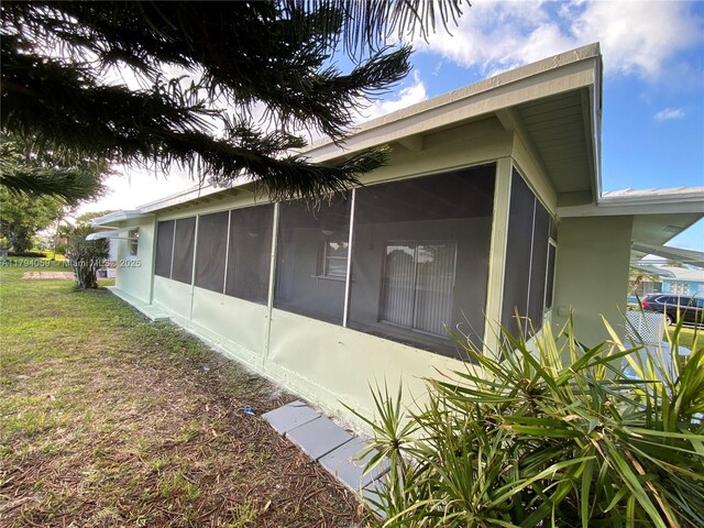 5009 NW 51st Ct, Tamarac, FL 33319 - view of home's exterior featuring a yard and a sunroom