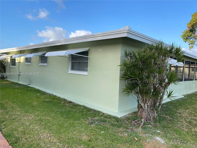5009 NW 51st Ct, Tamarac, FL 33319 - view of side of property with a yard and stucco siding