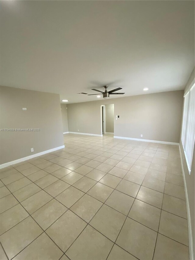 5009 NW 51st Ct, Tamarac, FL 33319 - spare room featuring baseboards, a ceiling fan, and light tile patterned flooring