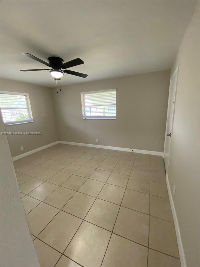 5009 NW 51st Ct, Tamarac, FL 33319 - unfurnished room with a ceiling fan, baseboards, plenty of natural light, and light tile patterned floors