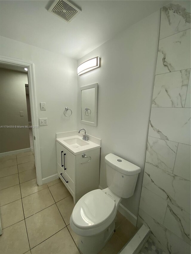 5009 NW 51st Ct, Tamarac, FL 33319 - bathroom with vanity, toilet, marble finish floor, baseboards, and visible vents