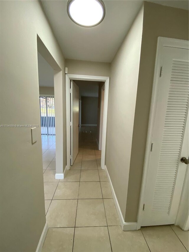 5009 NW 51st Ct, Tamarac, FL 33319 - corridor with baseboards and light tile patterned floors