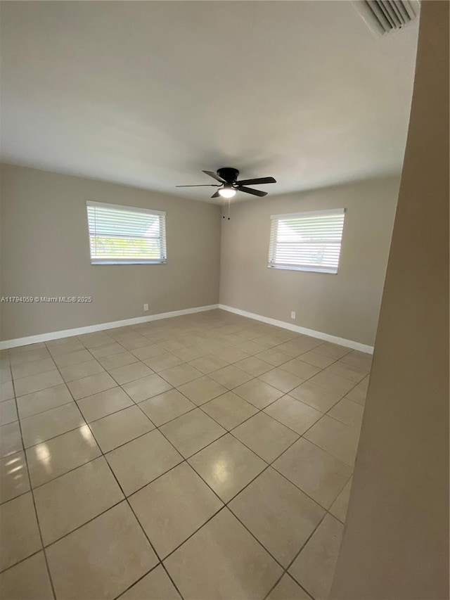 5009 NW 51st Ct, Tamarac, FL 33319 - spare room with a healthy amount of sunlight, light tile patterned floors, a ceiling fan, and visible vents