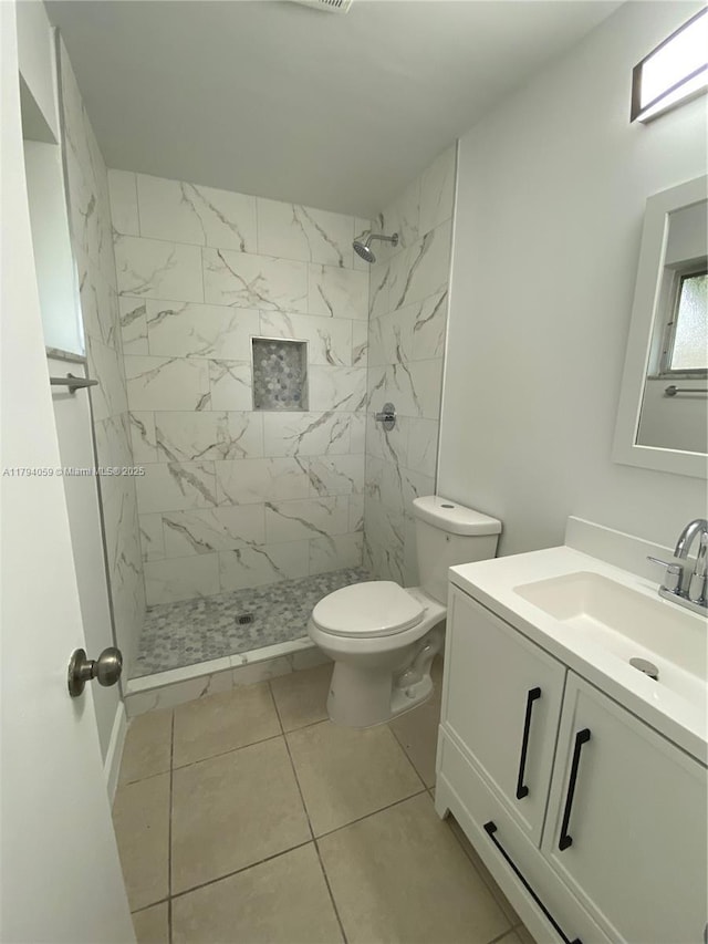 5009 NW 51st Ct, Tamarac, FL 33319 - bathroom featuring toilet, tile patterned floors, a tile shower, and vanity