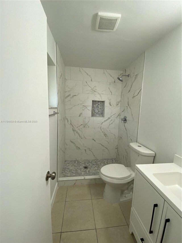 5009 NW 51st Ct, Tamarac, FL 33319 - bathroom featuring visible vents, vanity, toilet, tile patterned floors, and a stall shower