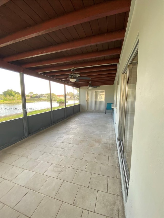 5009 NW 51st Ct, Tamarac, FL 33319 - unfurnished sunroom featuring a water view, beamed ceiling, and ceiling fan