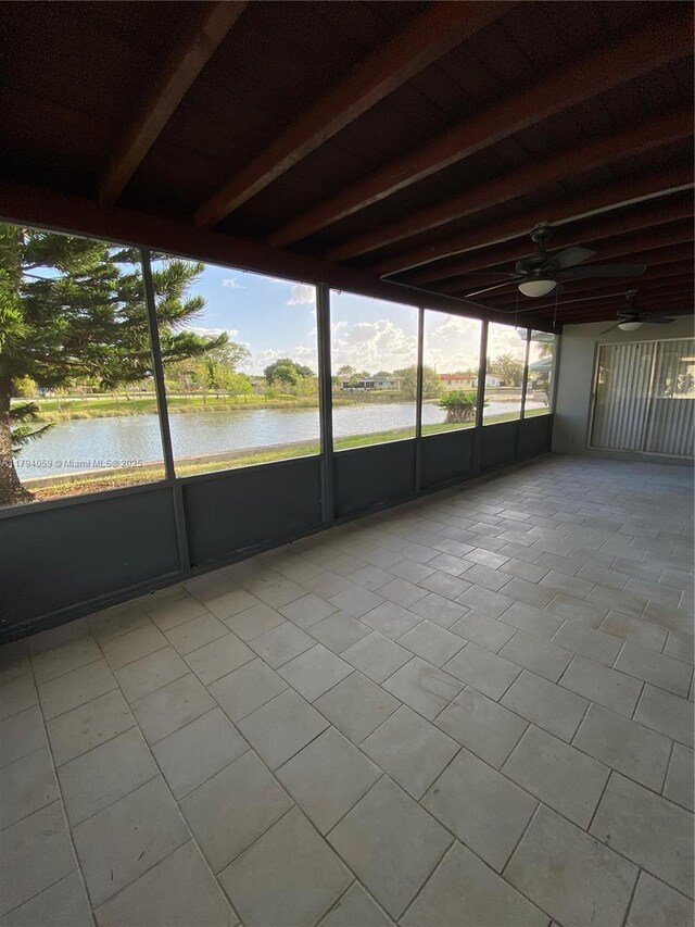 5009 NW 51st Ct, Tamarac, FL 33319 - unfurnished sunroom featuring a water view, ceiling fan, and beamed ceiling