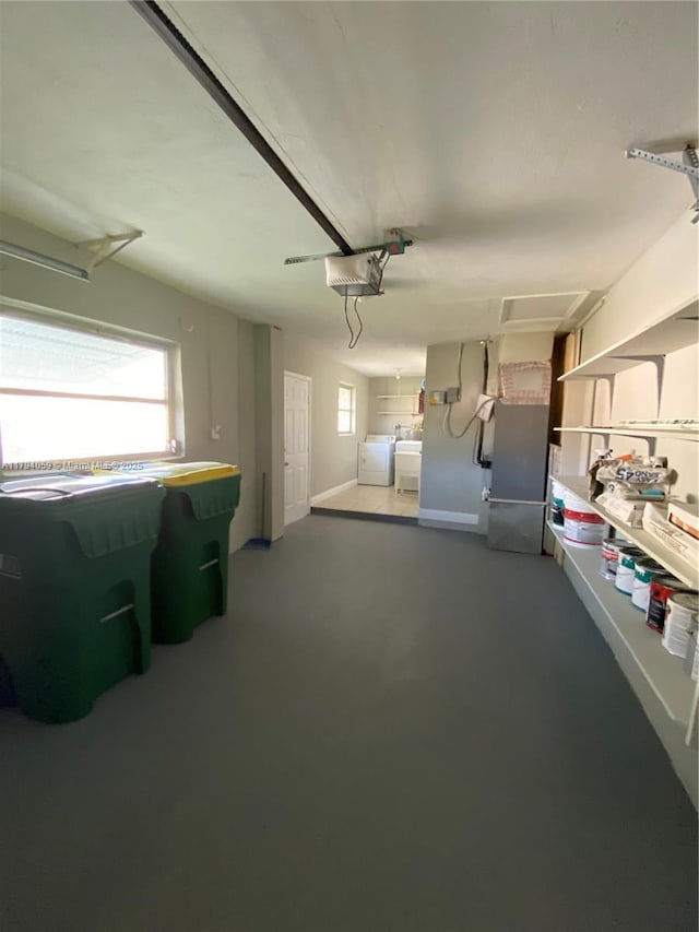 5009 NW 51st Ct, Tamarac, FL 33319 - garage featuring baseboards, a garage door opener, heating unit, and independent washer and dryer