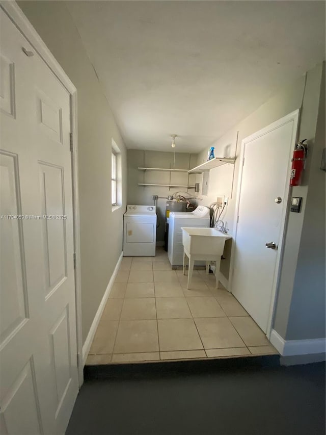 5009 NW 51st Ct, Tamarac, FL 33319 - laundry area featuring laundry area, baseboards, independent washer and dryer, and light tile patterned floors