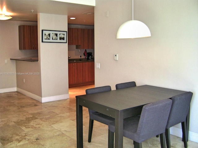 dining room featuring baseboards