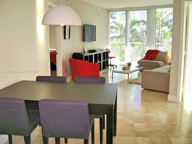 dining space with expansive windows and visible vents