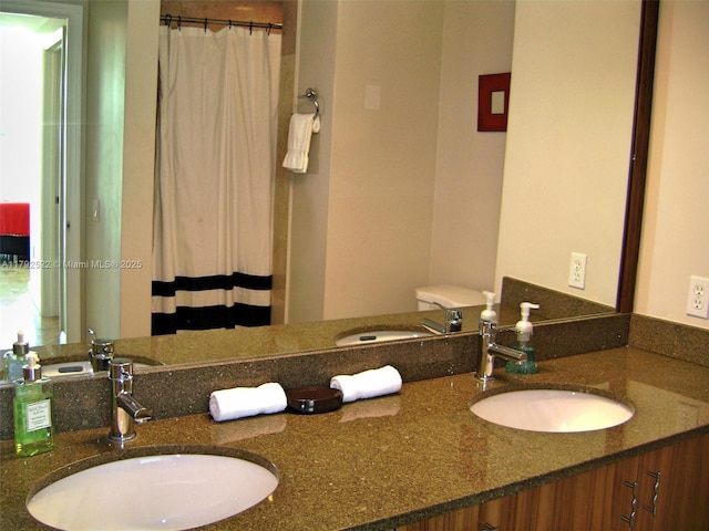 full bath with a sink, double vanity, and a shower with shower curtain