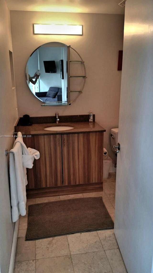 bathroom with vanity and toilet