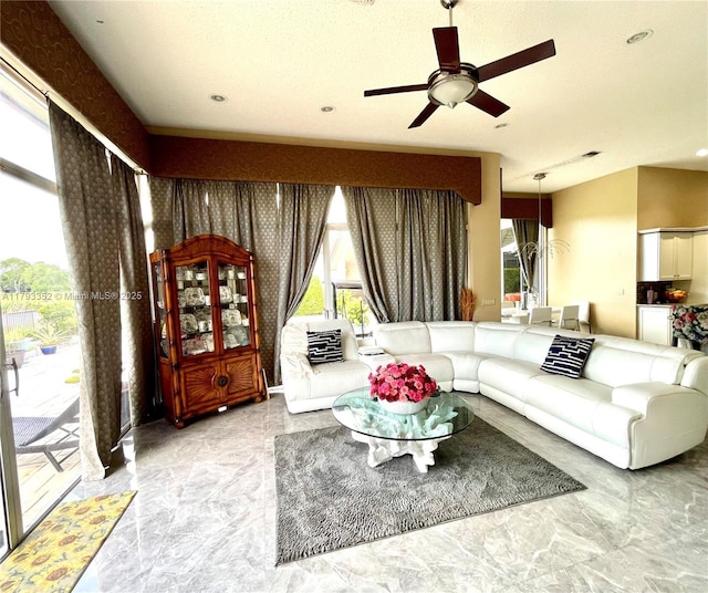 12022 Classic Dr, Coral Springs, FL 33071 - living area with marble tiled floors, a ceiling fan, and recessed lighting