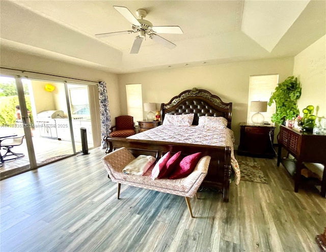12022 Classic Dr, Coral Springs, FL 33071 - bedroom with wood finished floors, access to exterior, a tray ceiling, and a ceiling fan
